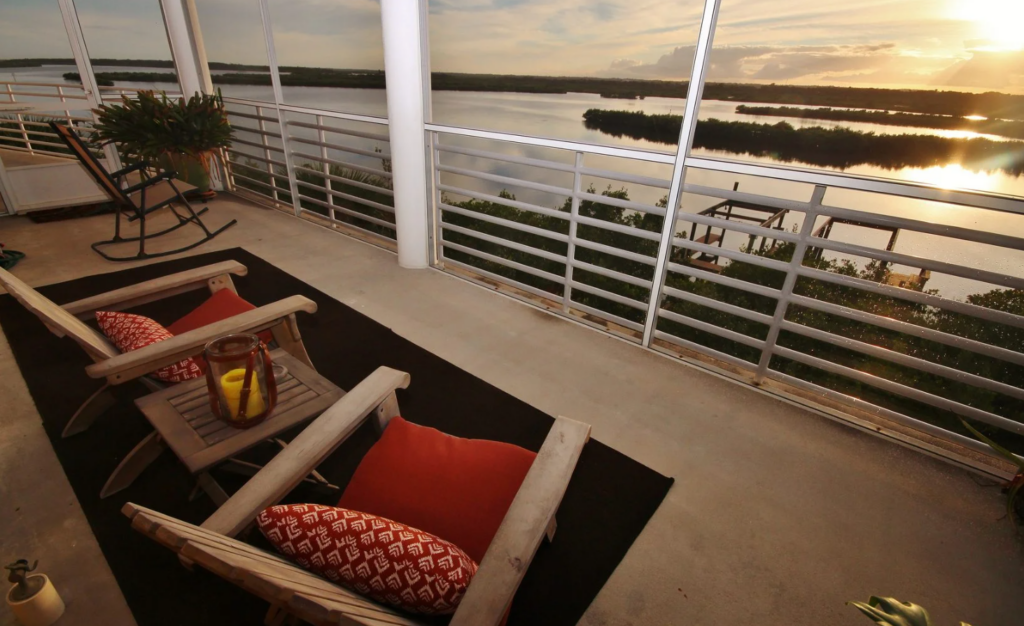 patio overlooking river with sunrise. 