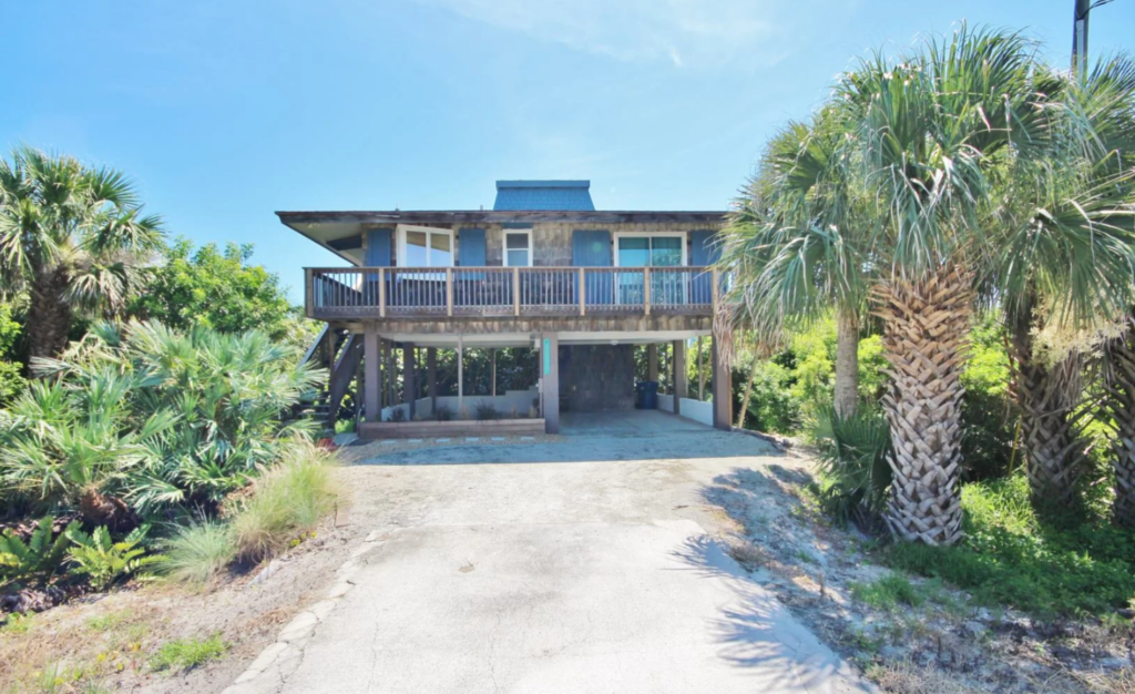 photo of blue house on stilts.